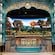 An expansive area with a tall theatrical stage, castle artwork and large lawn with amphitheater seating